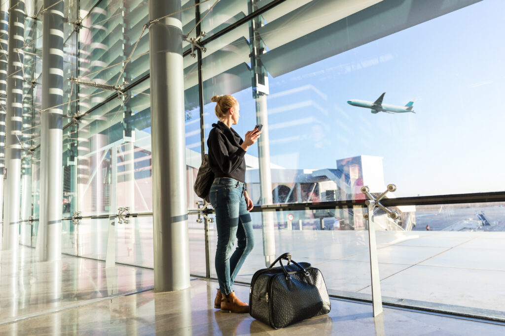 Female worker at the airport waiting to leave for her business travel.